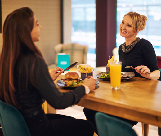 Image of women sitting and eating in the Clubroom
